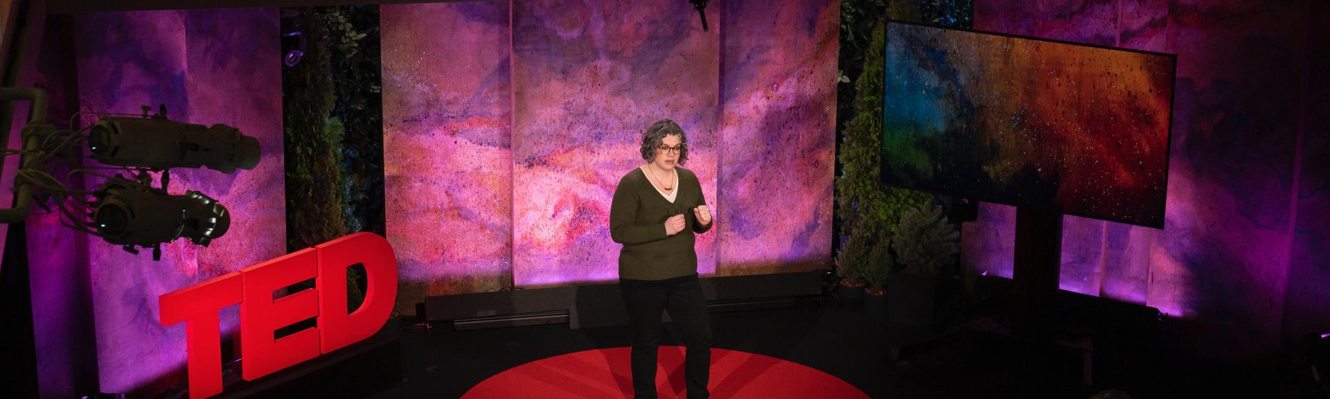 Alona Fyshe gives a TED talk on the TED stage.