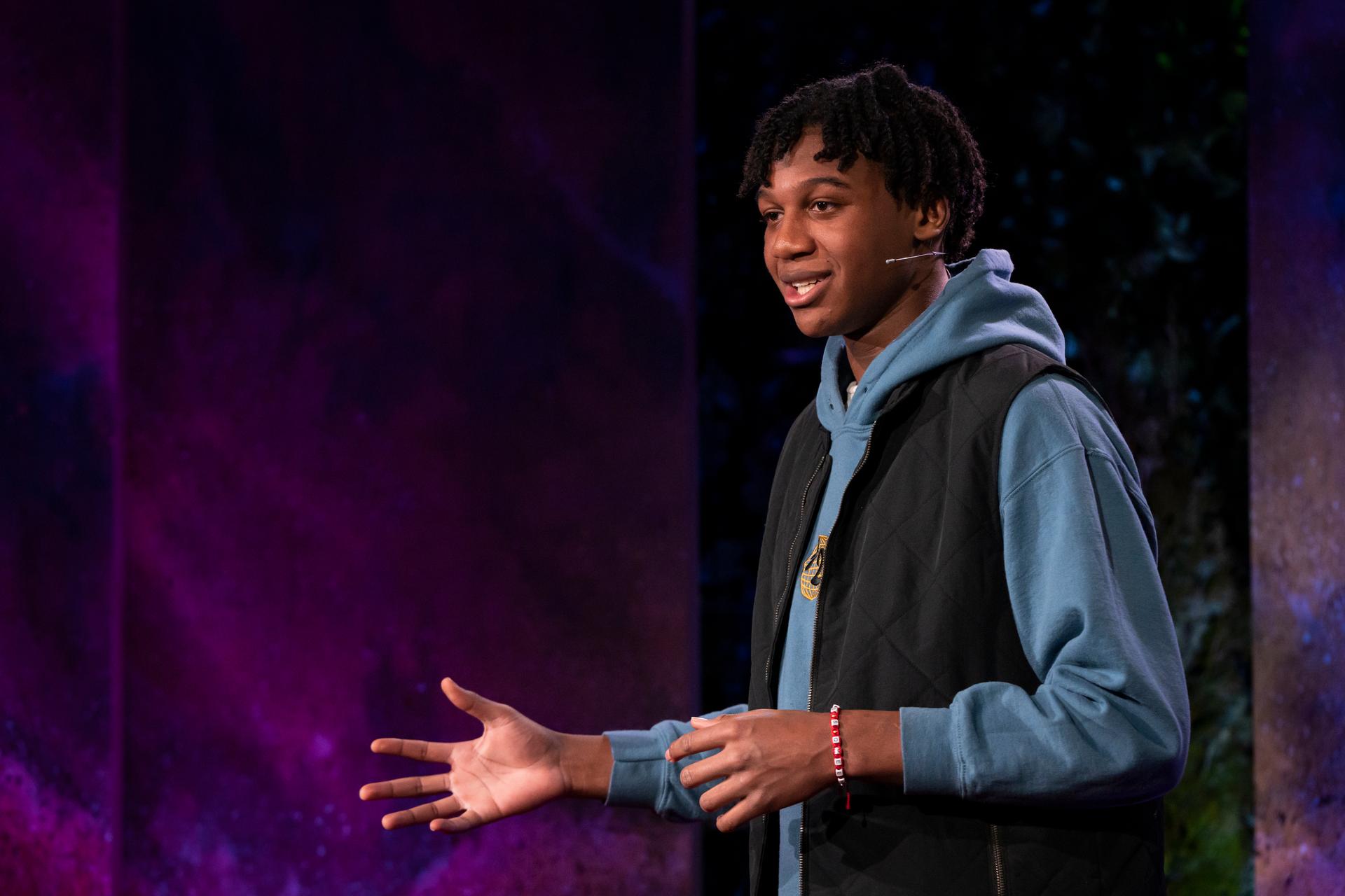 Cameron Davis gives a TED talk on the TED stage.