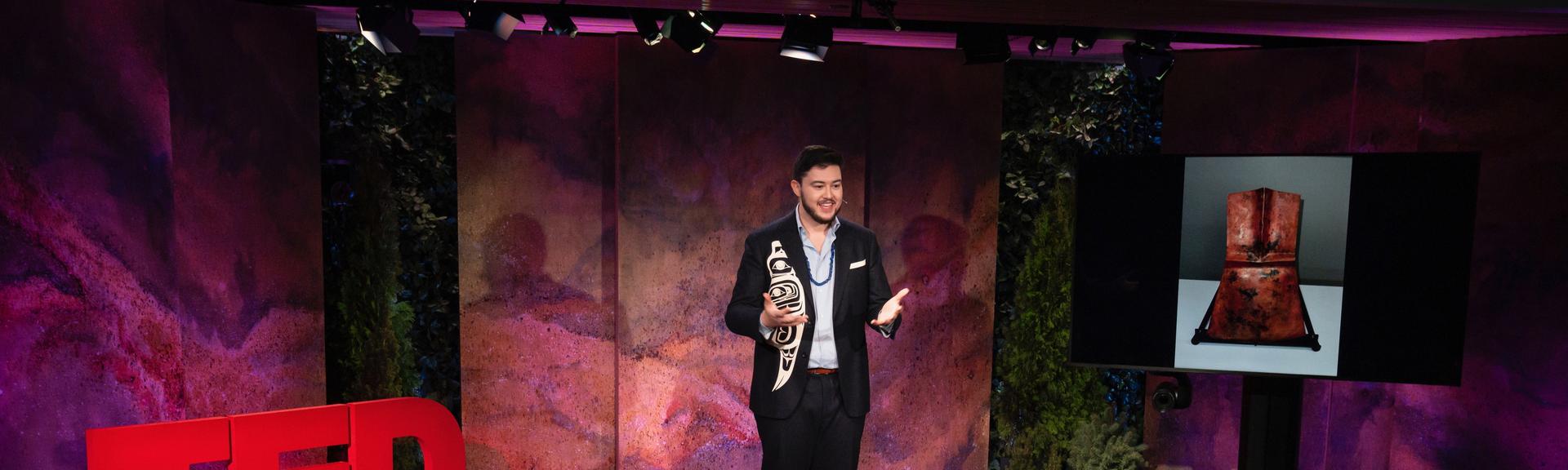 Cohen Bradley gives a TED talk on the TED stage.