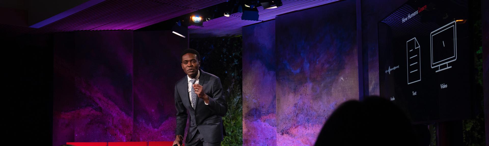 Kris Alexander gives a TED talk on the TED stage.