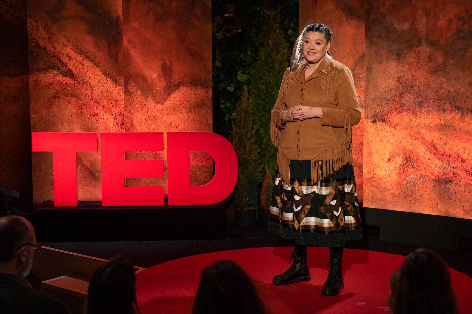 Matricia Bauer gives a TED talk on the TED stage.