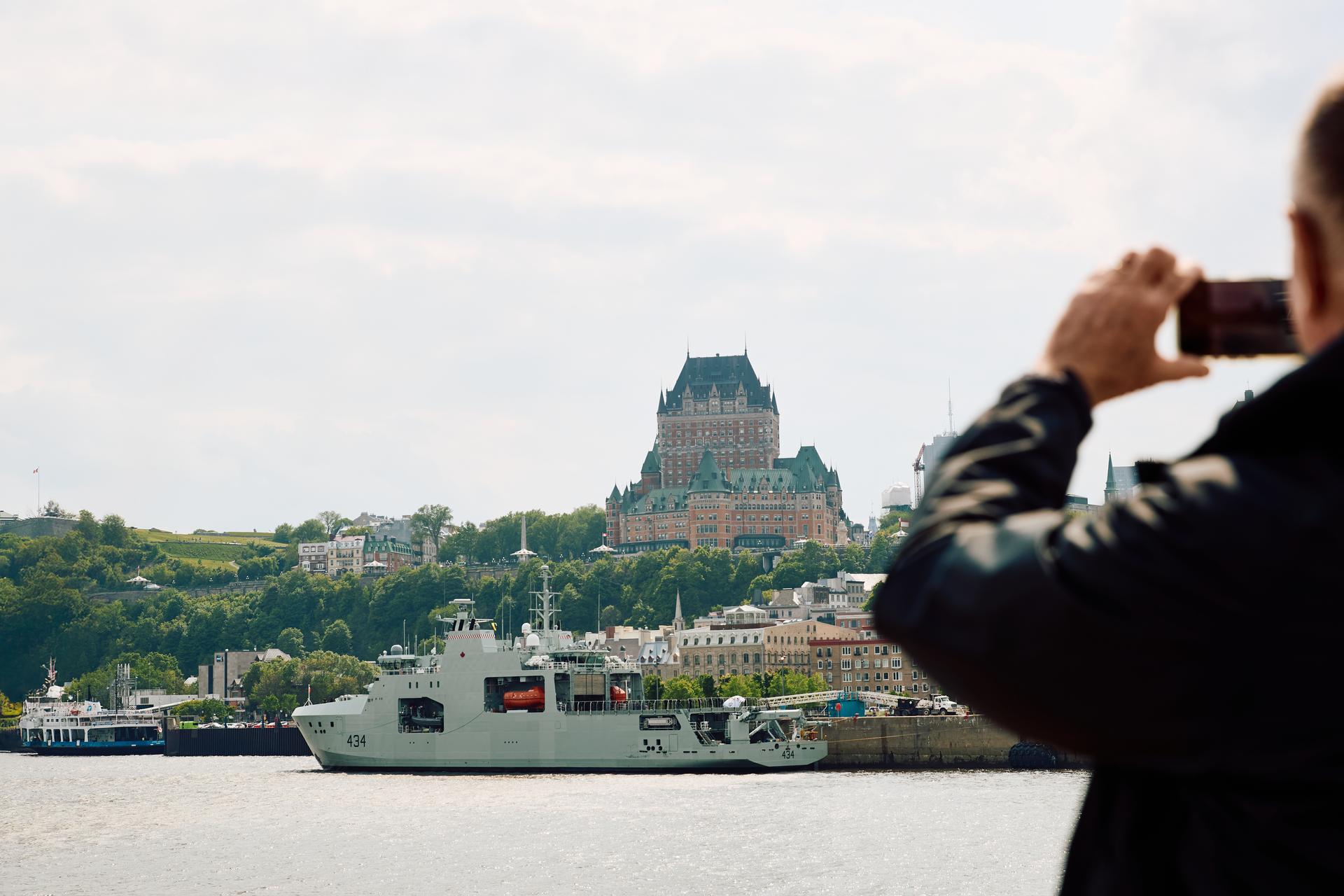 person holding a phone in quebec city on a boat